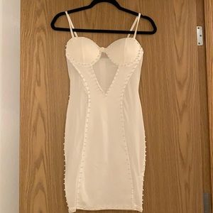 A sexy white pearl beaded dress. It has never been worn.